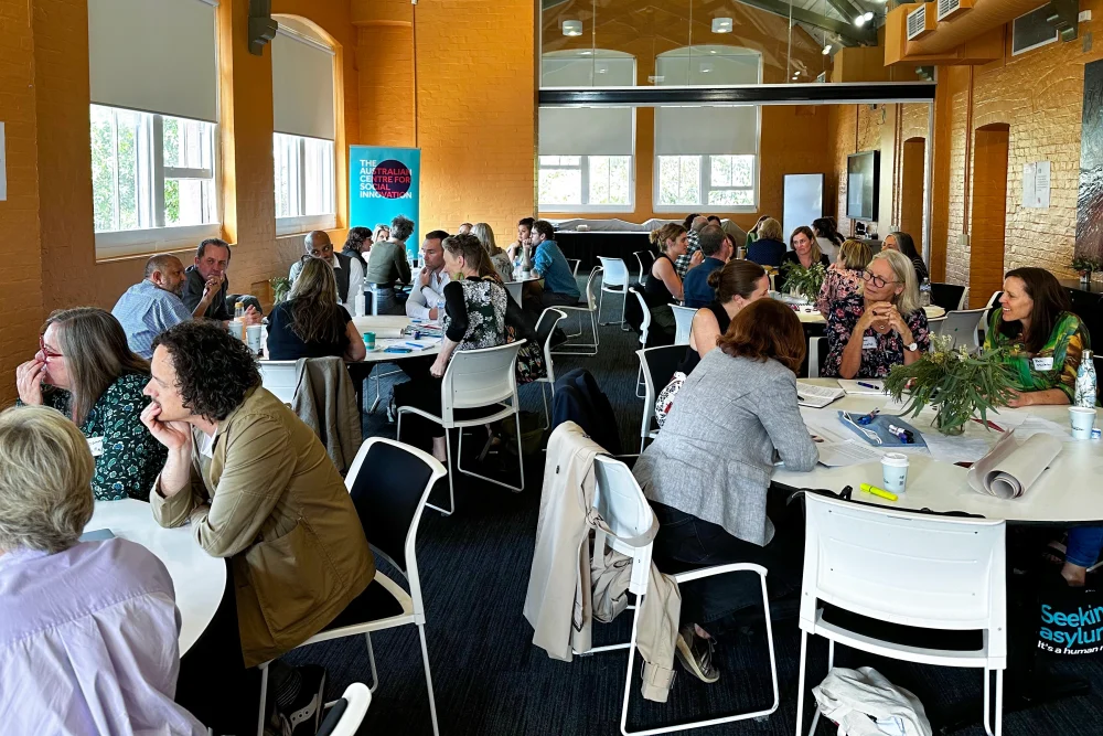 People talking around round tables at an event