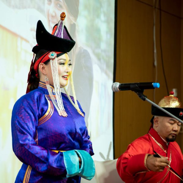 A person in traditional clothing doing a musical performance