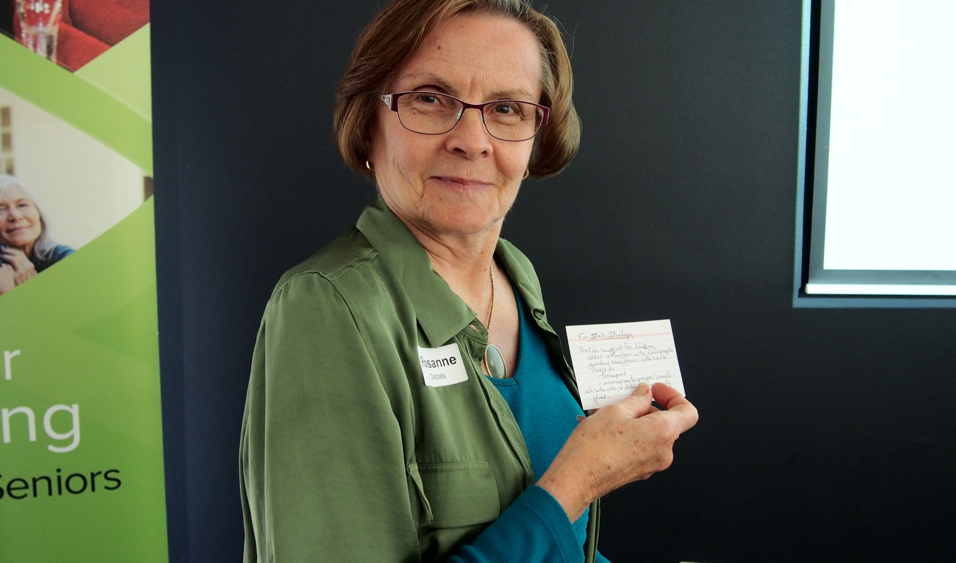 Older woman holding a card