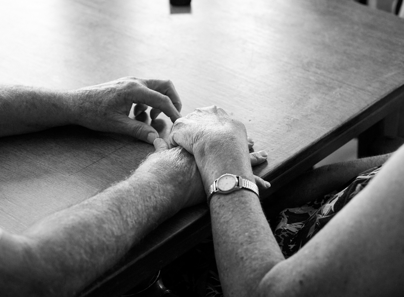 Holding hands resting on a table
