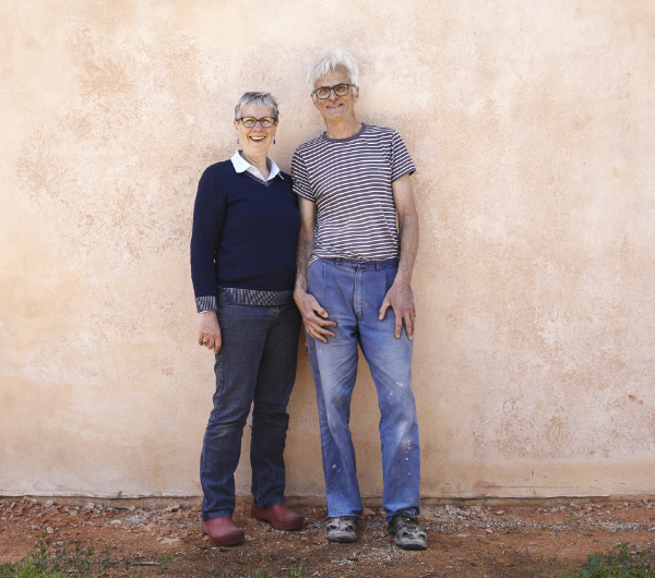 A couple standing against a wall