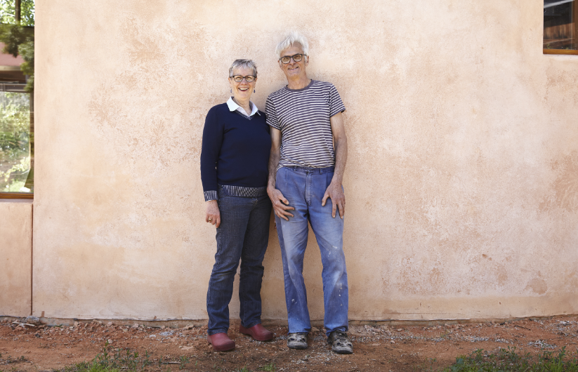 A couple standing against a wall