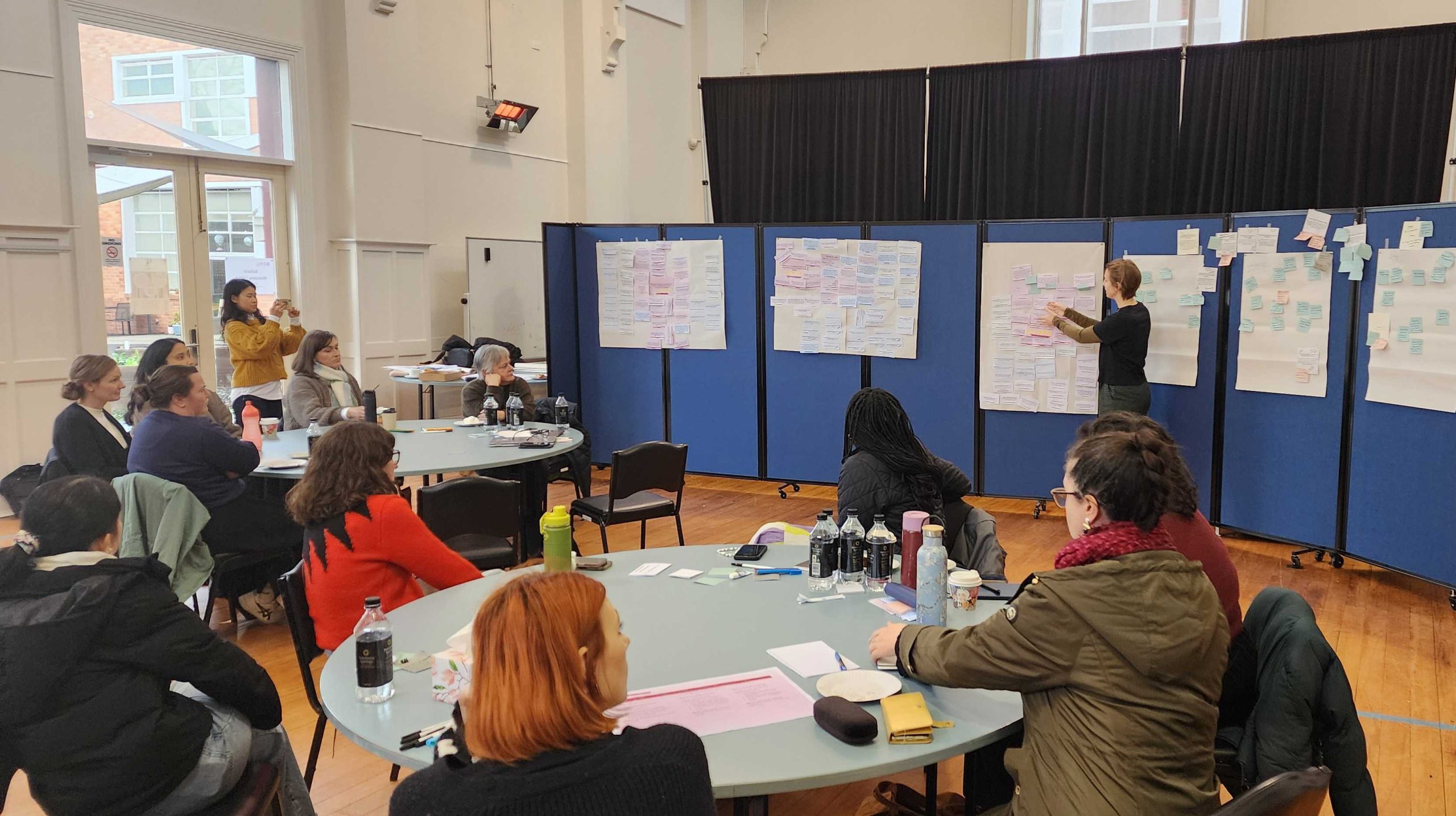 Person presenting at a workshop as people listen