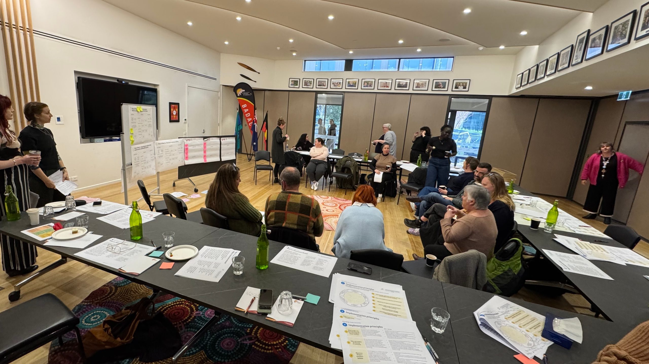 Person presenting at a workshop as people listen