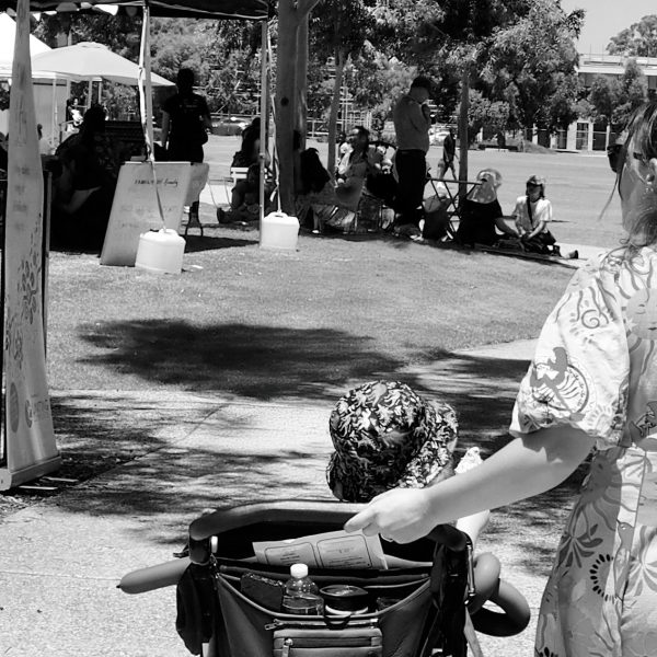 Mother pushing a child in a pram